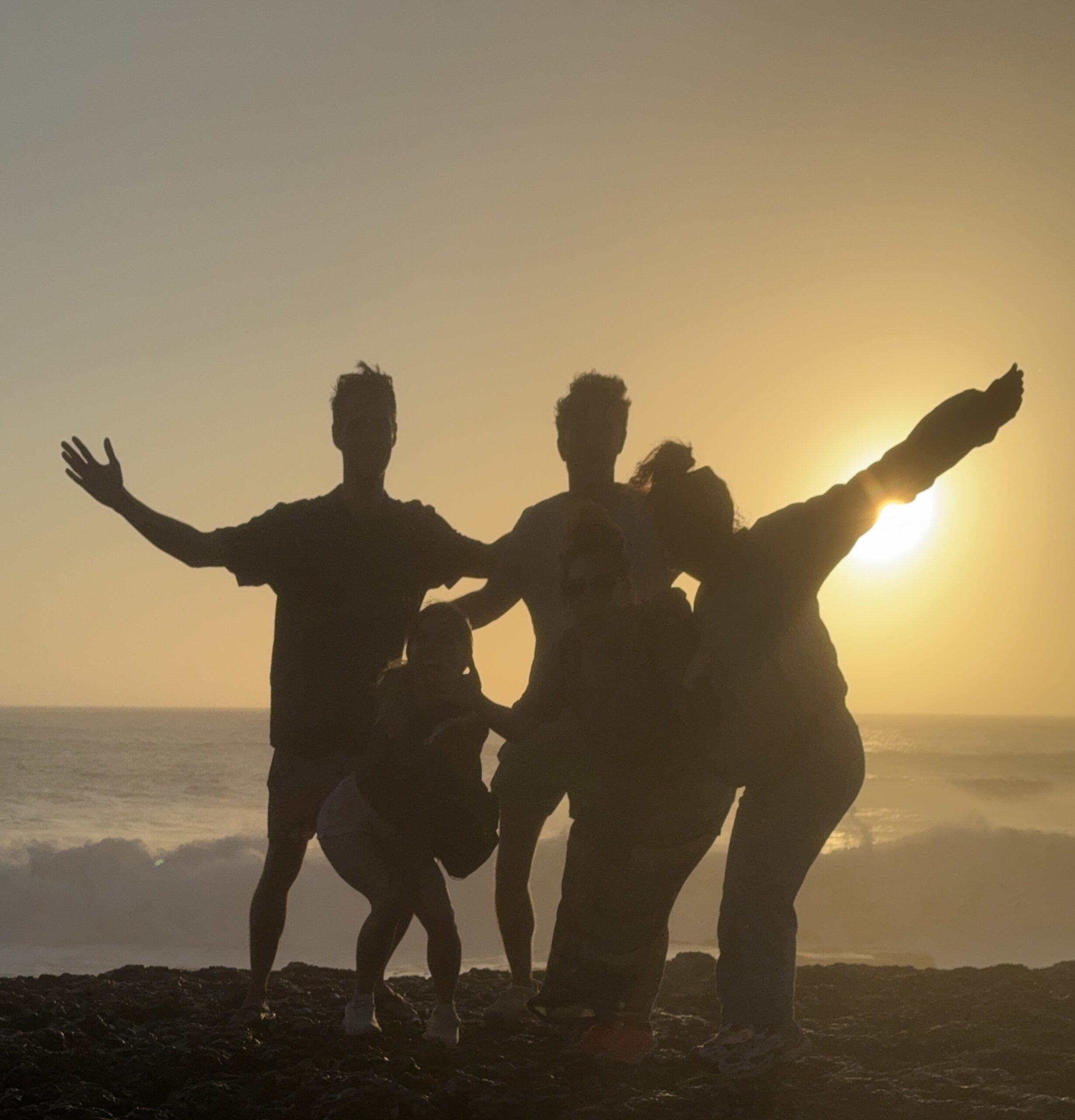 Friends together by the Atlantic at sunset